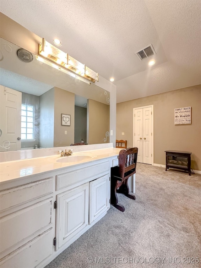 7515 S 108th E Ave, Tulsa, OK 74133 - bathroom with a textured ceiling, vanity, carpet floors, and recessed lighting