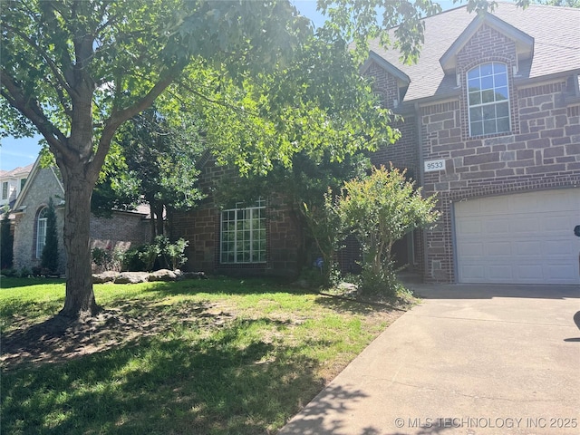 9533 S 88th E Ave, Tulsa, OK 74133 - view of front of property featuring concrete driveway, a front lawn, a garage, and brick siding