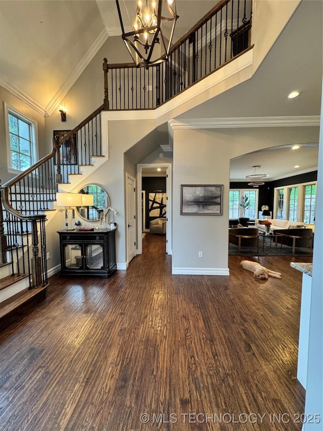 2920 E 27th Pl, Tulsa, OK 74114 - living room with a towering ceiling, stairway, plenty of natural light, wood finished floors, and ornamental molding
