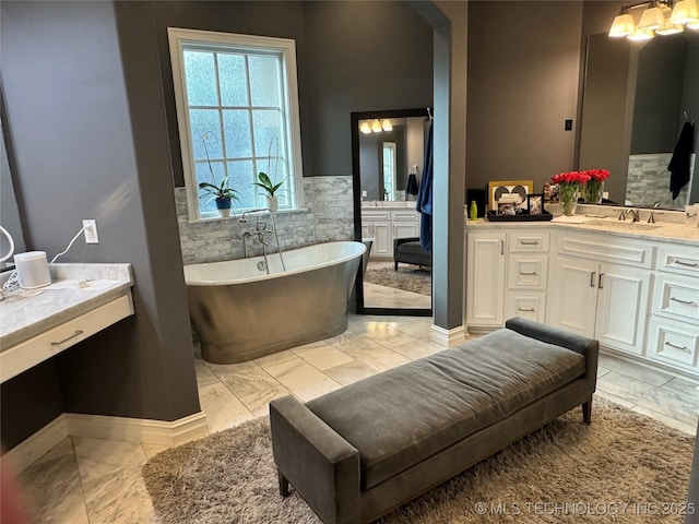 2920 E 27th Pl, Tulsa, OK 74114 - full bathroom featuring marble finish floors, vanity, and a freestanding bath