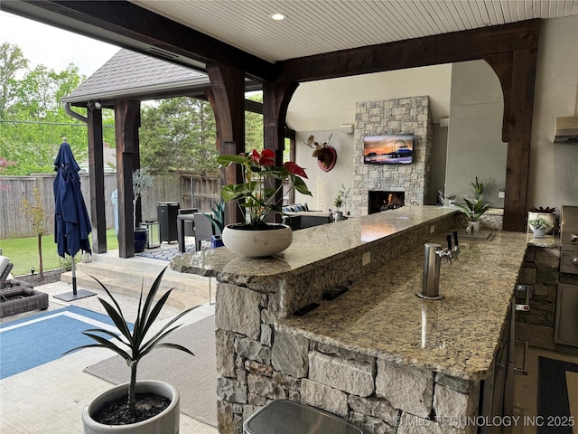 2920 E 27th Pl, Tulsa, OK 74114 - kitchen with an outdoor stone fireplace and stone counters