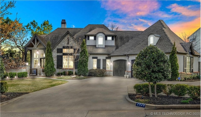 2920 E 27th Pl, Tulsa, OK 74114 - french country style house with stone siding, a garage, stucco siding, and a chimney