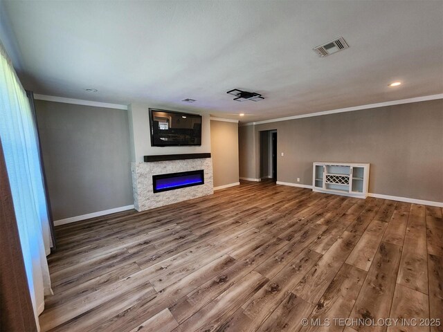 72078 S 321st Rd, Wagoner, OK 74467 - unfurnished living room with ornamental molding, a glass covered fireplace, wood finished floors, and recessed lighting