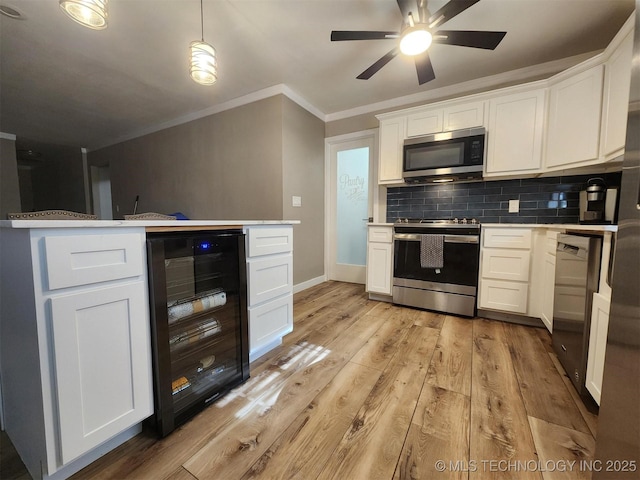 72078 S 321st Rd, Wagoner, OK 74467 - kitchen with appliances with stainless steel finishes, beverage cooler, ornamental molding, light wood-style floors, and ceiling fan