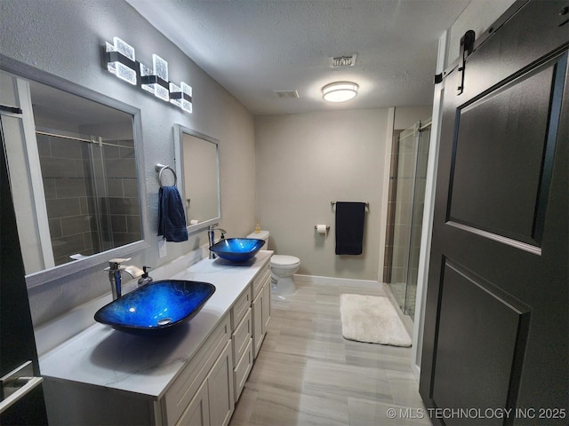 72078 S 321st Rd, Wagoner, OK 74467 - bathroom featuring double vanity, a textured ceiling, and tiled shower