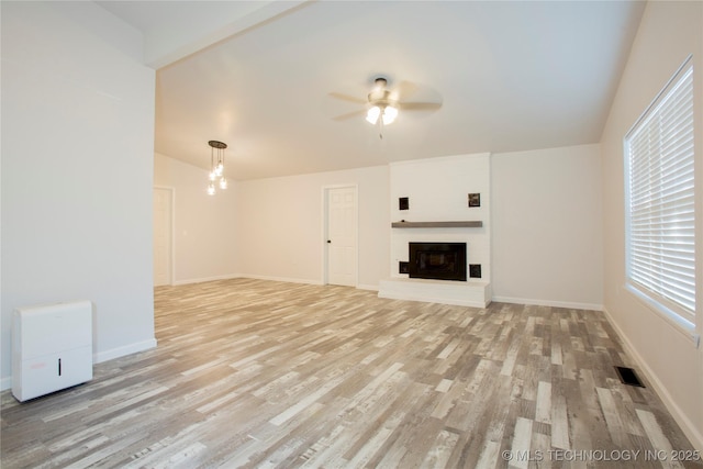 416434 Lakeside, Checotah, OK 74426 - unfurnished living room featuring light wood-style floors, a ceiling fan, and a glass covered fireplace