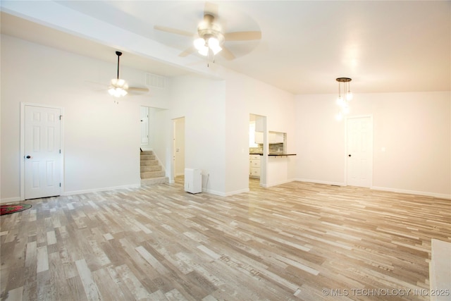 416434 Lakeside, Checotah, OK 74426 - unfurnished living room featuring a ceiling fan, light wood-style flooring, and stairway