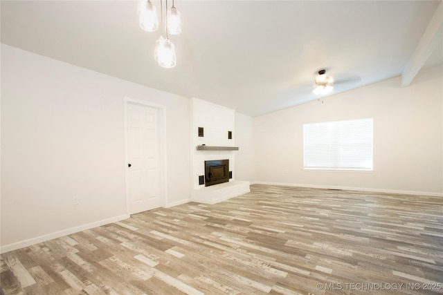 416434 Lakeside, Checotah, OK 74426 - unfurnished living room featuring vaulted ceiling, light wood finished floors, a fireplace with raised hearth, and ceiling fan