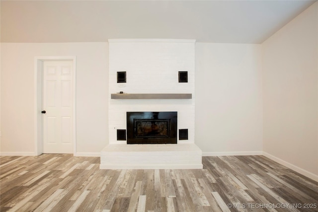 416434 Lakeside, Checotah, OK 74426 - unfurnished living room with wood finished floors and a large fireplace