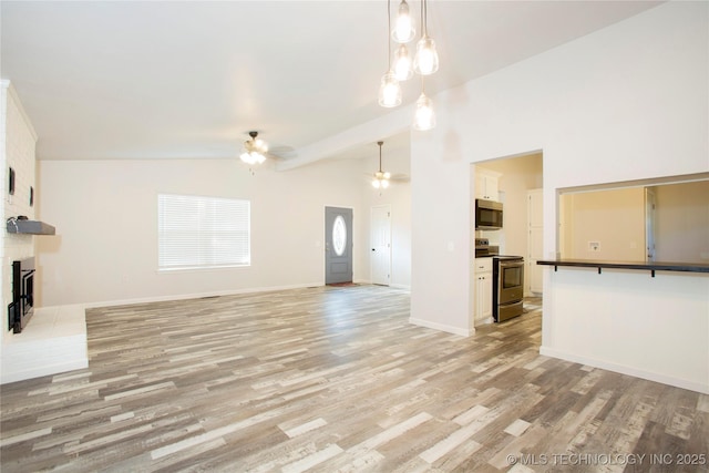 416434 Lakeside, Checotah, OK 74426 - unfurnished living room featuring a ceiling fan, light wood-style flooring, and a fireplace