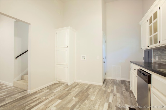 416434 Lakeside, Checotah, OK 74426 - kitchen featuring dishwasher, light wood-type flooring, white cabinetry, and a high ceiling