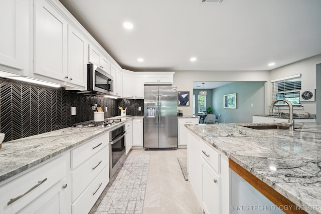 7705 S 232nd E Ave, Broken Arrow, OK 74014 - kitchen featuring appliances with stainless steel finishes, healthy amount of natural light, backsplash, and recessed lighting