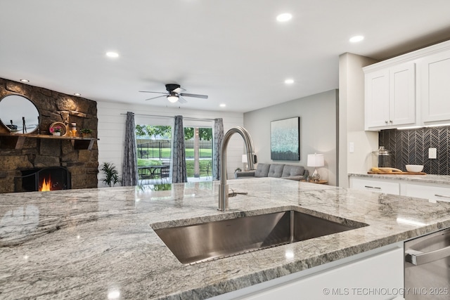 7705 S 232nd E Ave, Broken Arrow, OK 74014 - kitchen featuring stainless steel dishwasher, open floor plan, light stone counters, a ceiling fan, and recessed lighting