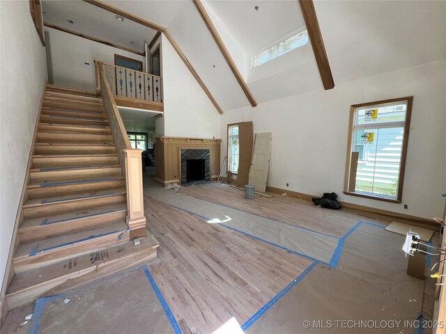 4954 S Boston Pl, Tulsa, OK 74105 - unfurnished living room featuring high vaulted ceiling, stairs, and a fireplace