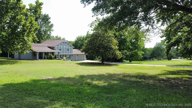 9802 E Clover Creek Dr, Claremore, OK 74017 - view of green lawn featuring a garage