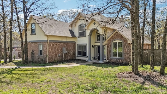 12916 E 181st St S, Bixby, OK 74008 - back of property featuring a lawn, brick siding, roof with shingles, and stucco siding