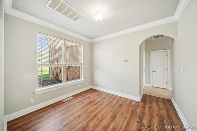 12916 E 181st St S, Bixby, OK 74008 - spare room featuring arched walkways, wood finished floors, and crown molding