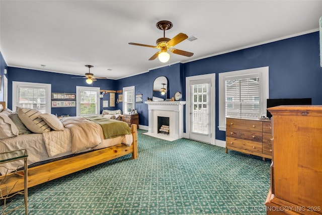 1006 E 17th Pl, Tulsa, OK 74120 - bedroom with carpet floors, a fireplace with flush hearth, access to exterior, a ceiling fan, and ornamental molding