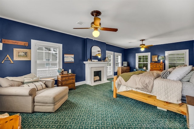1006 E 17th Pl, Tulsa, OK 74120 - carpeted bedroom with multiple windows, a fireplace with flush hearth, and ceiling fan