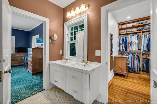 1006 E 17th Pl, Tulsa, OK 74120 - bathroom with double vanity, a walk in closet, and ornamental molding