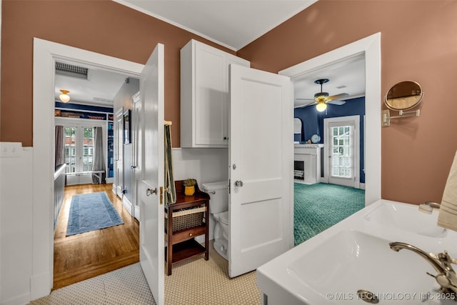 1006 E 17th Pl, Tulsa, OK 74120 - bathroom with french doors, a fireplace, and a ceiling fan