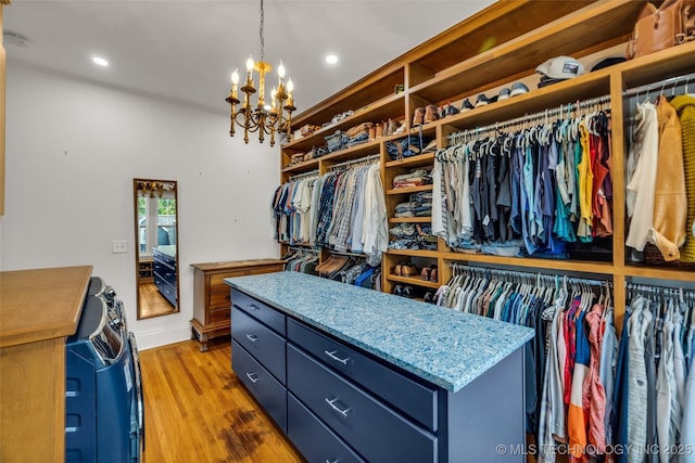 1006 E 17th Pl, Tulsa, OK 74120 - walk in closet featuring wood finished floors and a chandelier