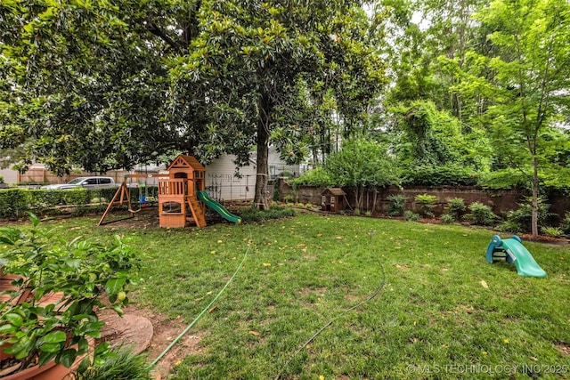 1006 E 17th Pl, Tulsa, OK 74120 - fenced backyard with a playground