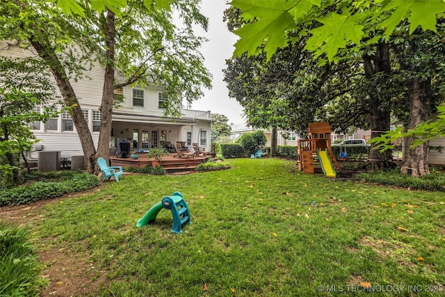 1006 E 17th Pl, Tulsa, OK 74120 - view of green lawn featuring a playground, a wooden deck, and french doors