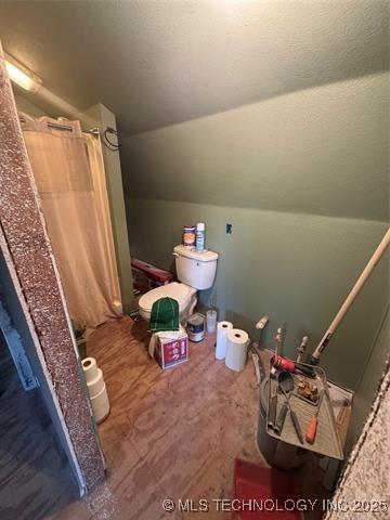 4495 Norfolk Ave, Beggs, OK 74421 - bathroom with vaulted ceiling and curtained shower