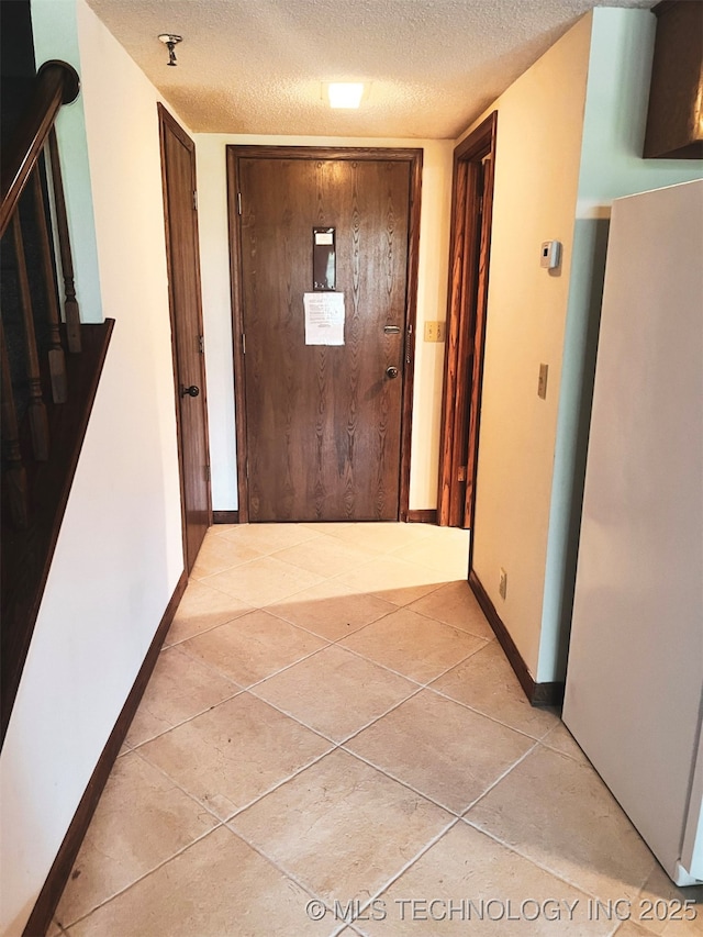 56701 E 310th Rd Unit 712, Afton, OK 74331 - corridor featuring a textured ceiling and light tile patterned floors