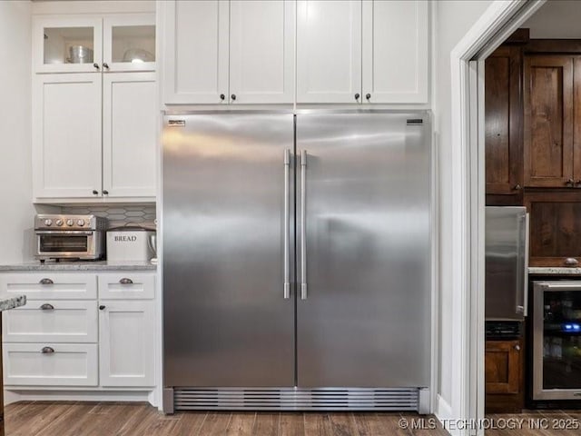 4270 S 4110th Rd, Talala, OK 74080 - kitchen featuring stainless steel built in refrigerator, wine cooler, white cabinets, wood finished floors, and light stone counters