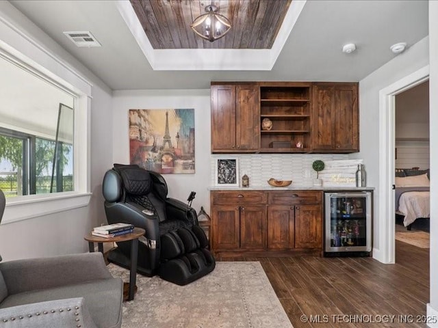 4270 S 4110th Rd, Talala, OK 74080 - bar featuring beverage cooler, dark wood-type flooring, a tray ceiling, and tasteful backsplash