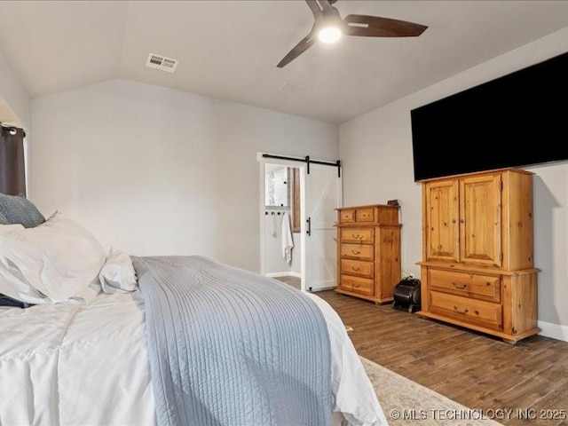 4270 S 4110th Rd, Talala, OK 74080 - bedroom with wood finished floors, a barn door, vaulted ceiling, and a ceiling fan