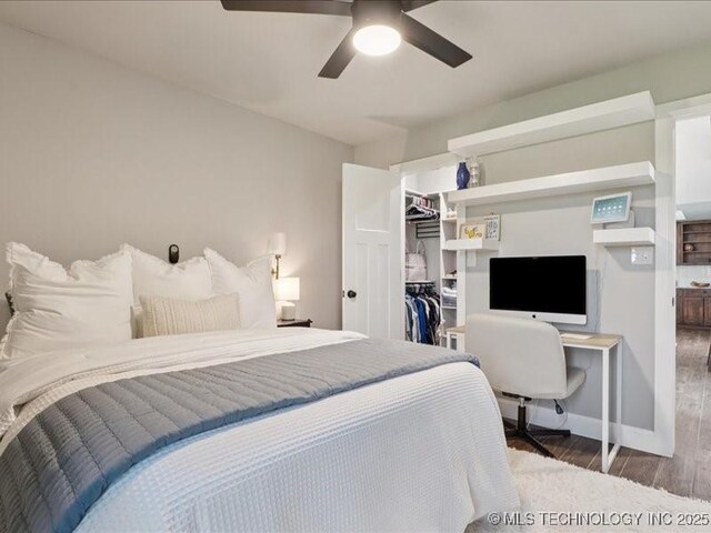 4270 S 4110th Rd, Talala, OK 74080 - bedroom with wood finished floors, a walk in closet, a closet, a ceiling fan, and a desk