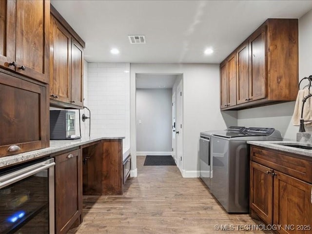 4270 S 4110th Rd, Talala, OK 74080 - laundry area with independent washer and dryer, light wood-style floors, recessed lighting, and beverage cooler