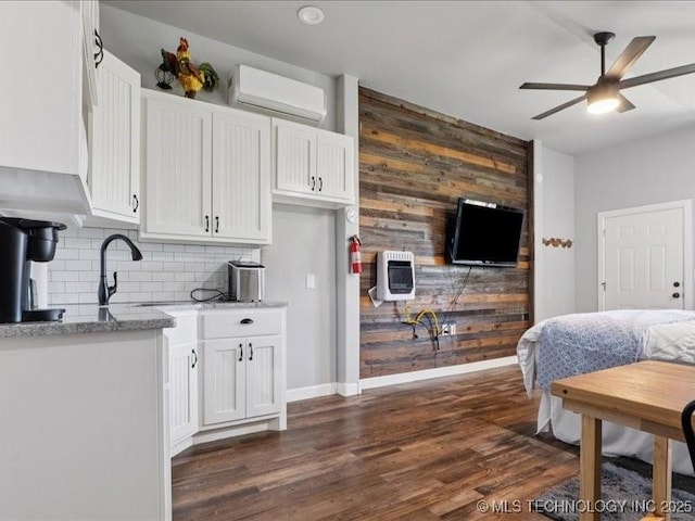 4270 S 4110th Rd, Talala, OK 74080 - bedroom with an AC wall unit, dark wood finished floors, heating unit, and wood walls