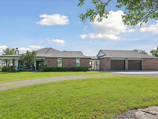 4270 S 4110th Rd, Talala, OK 74080 - view of front facade with driveway, a front lawn, a garage, and brick siding
