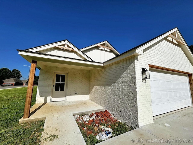 2005 N Alora Ave, Tahlequah, OK 74464 - ranch-style home featuring brick siding, an attached garage, and board and batten siding