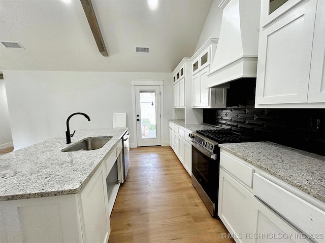 2005 N Alora Ave, Tahlequah, OK 74464 - kitchen featuring gas stove, custom exhaust hood, stainless steel dishwasher, light wood-style floors, and tasteful backsplash