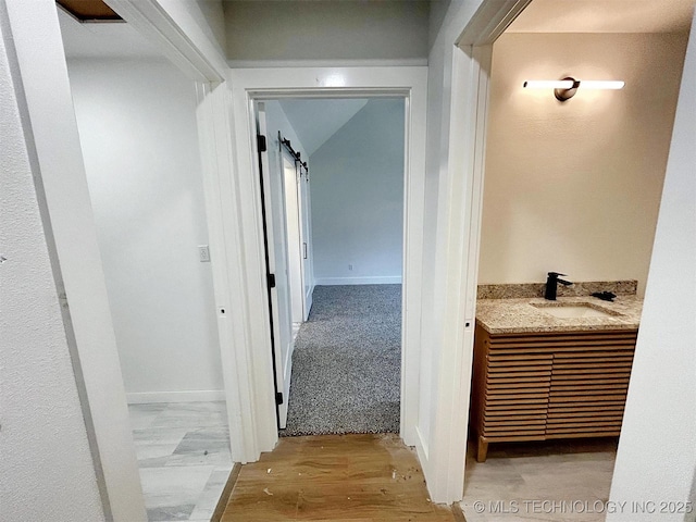2005 N Alora Ave, Tahlequah, OK 74464 - hallway featuring wood finished floors and a barn door