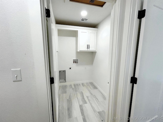2005 N Alora Ave, Tahlequah, OK 74464 - laundry room with cabinet space, washer hookup, hookup for an electric dryer, and light wood-style flooring