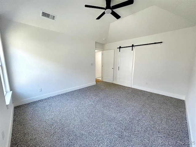 2005 N Alora Ave, Tahlequah, OK 74464 - unfurnished bedroom featuring a barn door, lofted ceiling, and ceiling fan