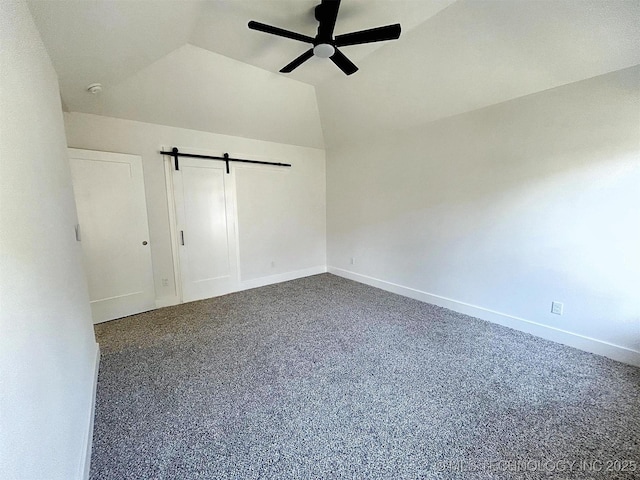 2005 N Alora Ave, Tahlequah, OK 74464 - unfurnished bedroom with a barn door, vaulted ceiling, ceiling fan, and carpet