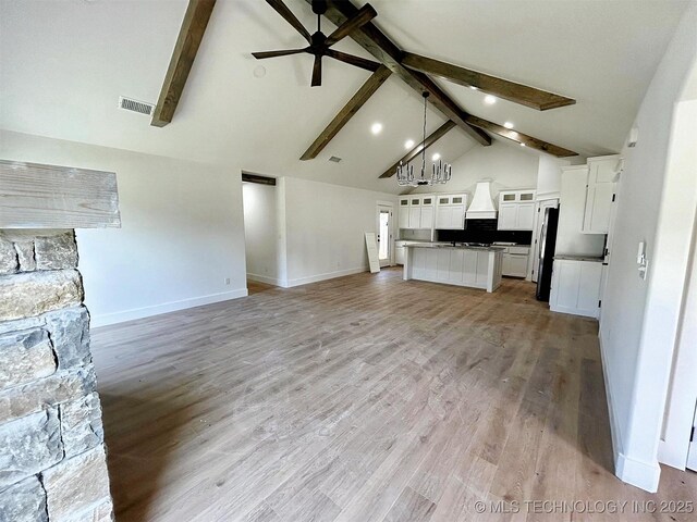 2005 N Alora Ave, Tahlequah, OK 74464 - unfurnished living room with beam ceiling, ceiling fan, light wood-type flooring, and high vaulted ceiling