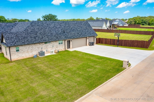 12349 County Road 3571, Ada, OK 74820 - back of property featuring concrete driveway, a shingled roof, a garage, and brick siding