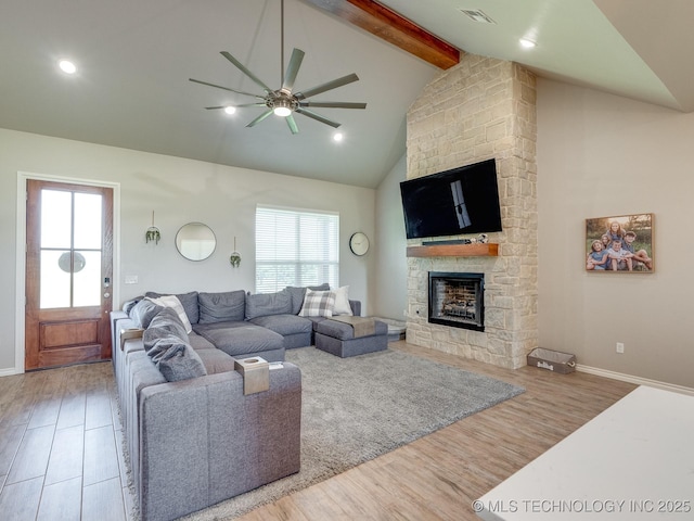 12349 County Road 3571, Ada, OK 74820 - living area featuring a ceiling fan, wood finished floors, beamed ceiling, a fireplace, and high vaulted ceiling