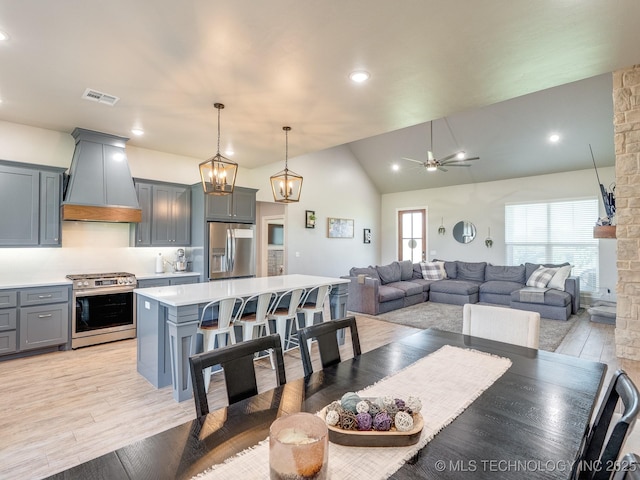 12349 County Road 3571, Ada, OK 74820 - dining room with a ceiling fan, vaulted ceiling, light wood-type flooring, a chandelier, and recessed lighting
