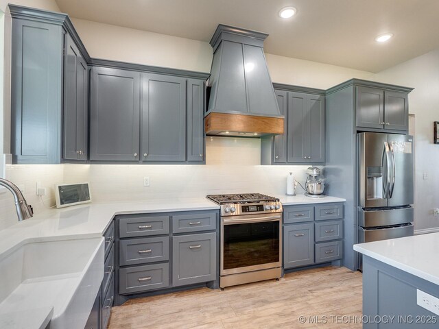 12349 County Road 3571, Ada, OK 74820 - kitchen featuring appliances with stainless steel finishes, premium range hood, backsplash, light countertops, and recessed lighting