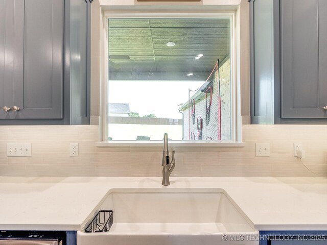 12349 County Road 3571, Ada, OK 74820 - kitchen with backsplash, light countertops, and gray cabinetry