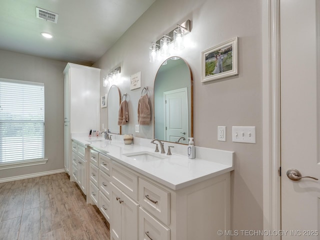 12349 County Road 3571, Ada, OK 74820 - full bathroom with double vanity and wood finished floors